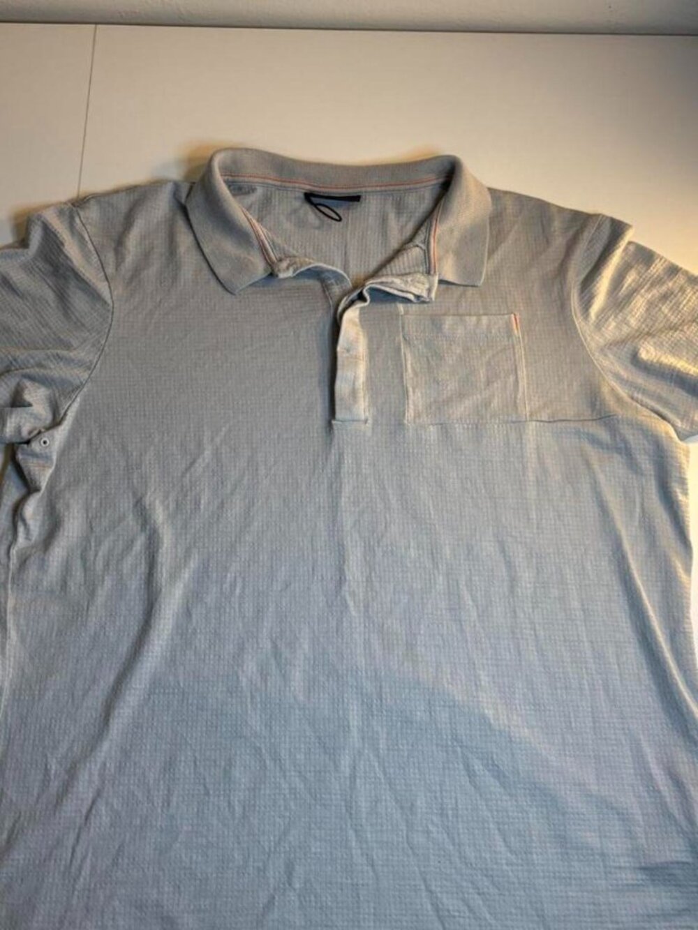 The North Face Icebreaker light blue polo shirt